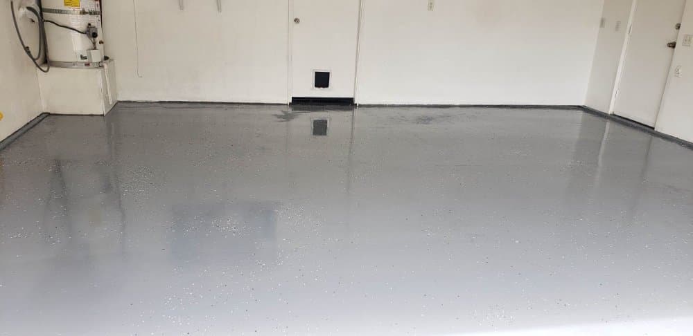 Finished gray epoxy garage floor with a flake coating installed in a San Diego garage by Junk N Haul