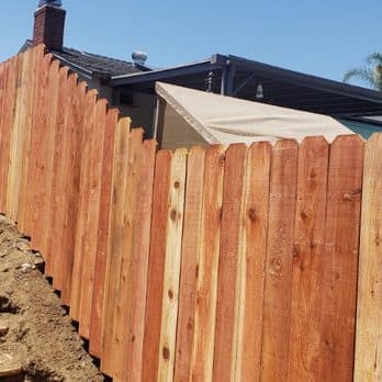 New redwood privacy fence installed along a San Diego backyard by Junk N Haul